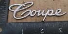 Cadillac Coupe Circa '68 Script Metal Emblem 1483602 3390 Used. Price: $16.00.
