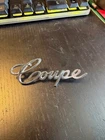 Nos Gm 3632585 "coupe" Chrome Emblem For 71-74 Cadillac Deville Sedan Used. Price: $100.00.